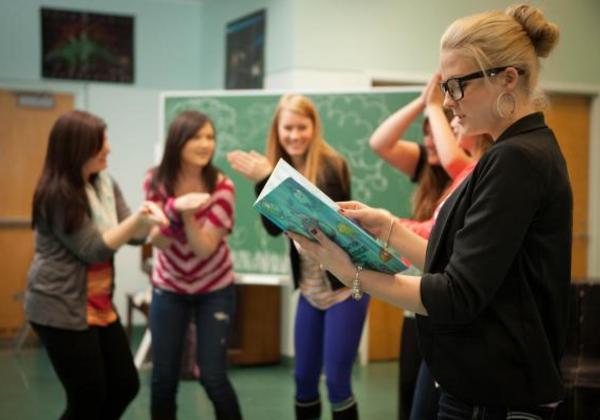 Teacher and female students working together in a classroom