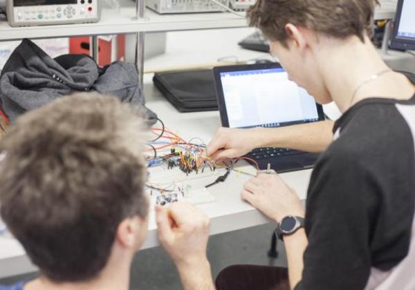 Two young men working in a computer lab