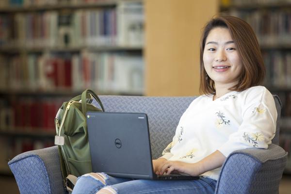 A Student of the Bachelor of Arts, Minor in Digital Media program studying in the library
