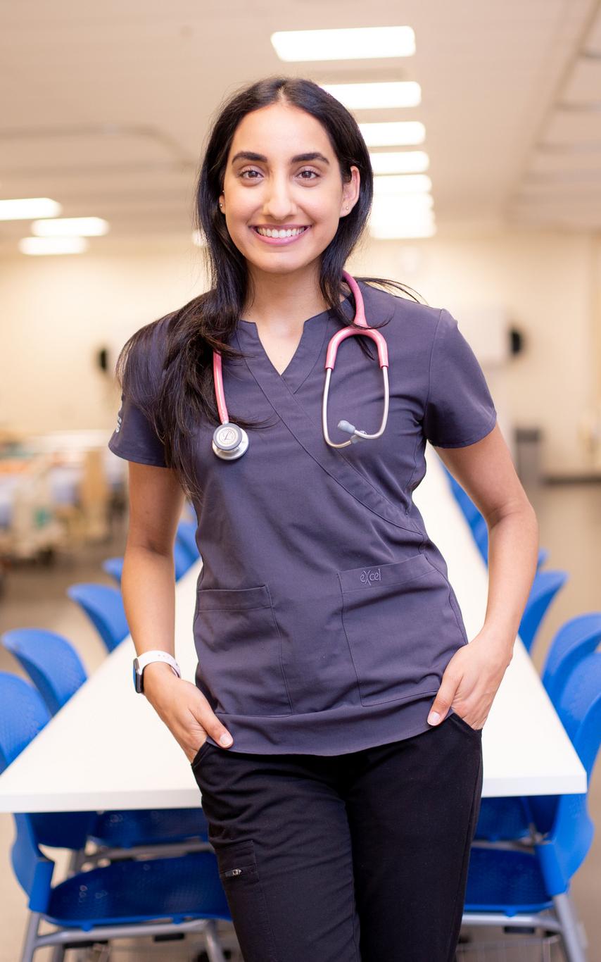 Smiling nursing student with long dark hair and purple top