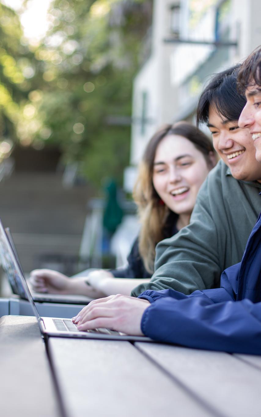 VIU students on laptops working outside