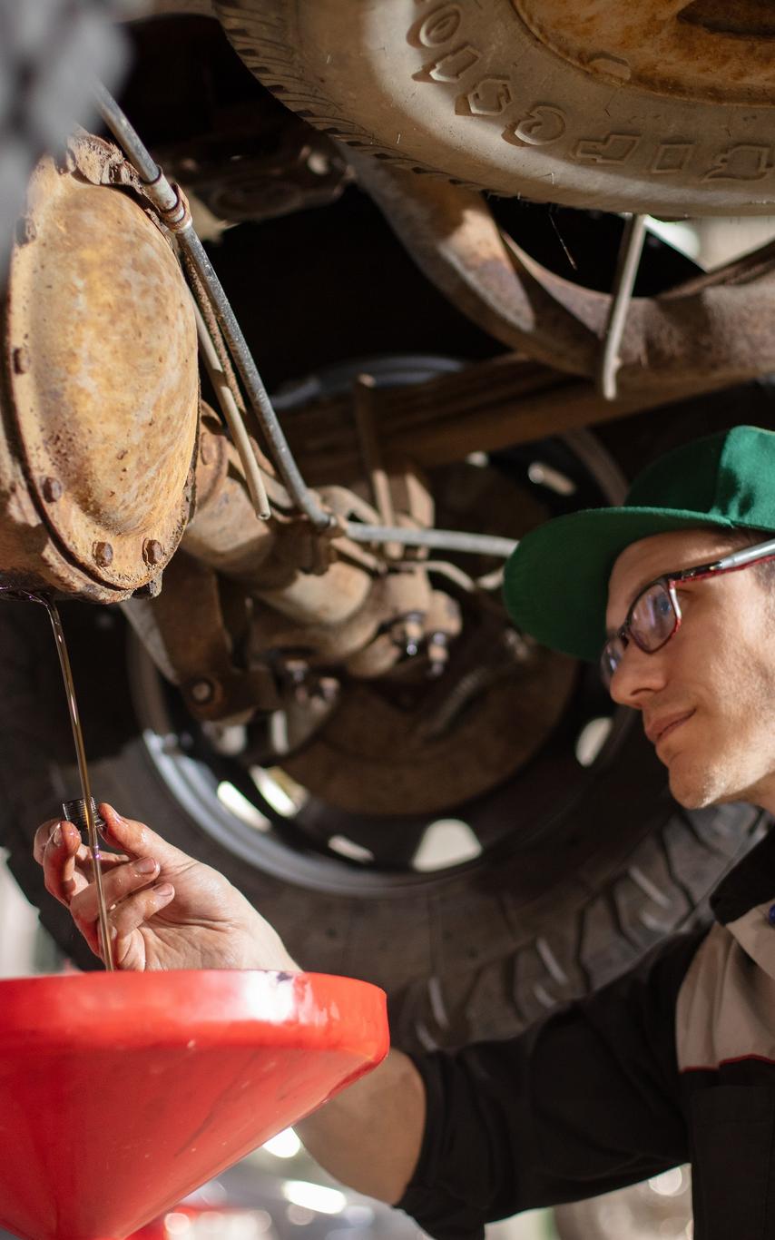 Two automotive students working under an automobile