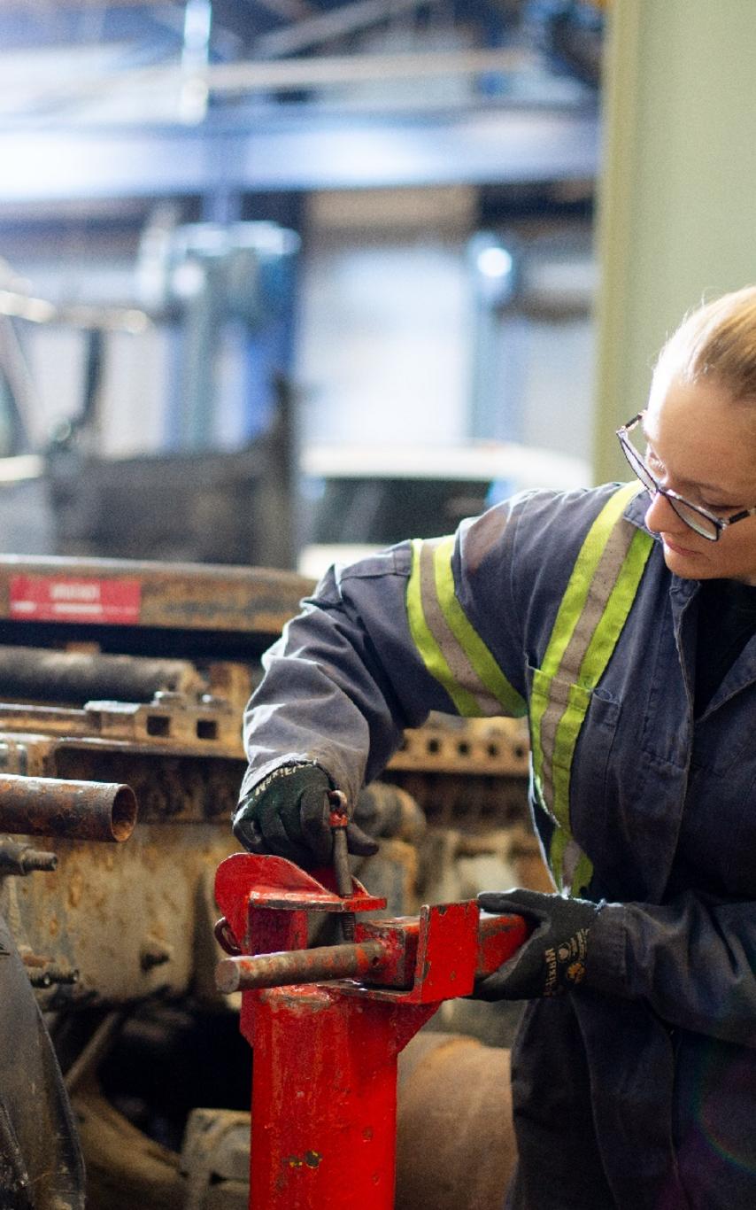 Young woman working in a machine shop